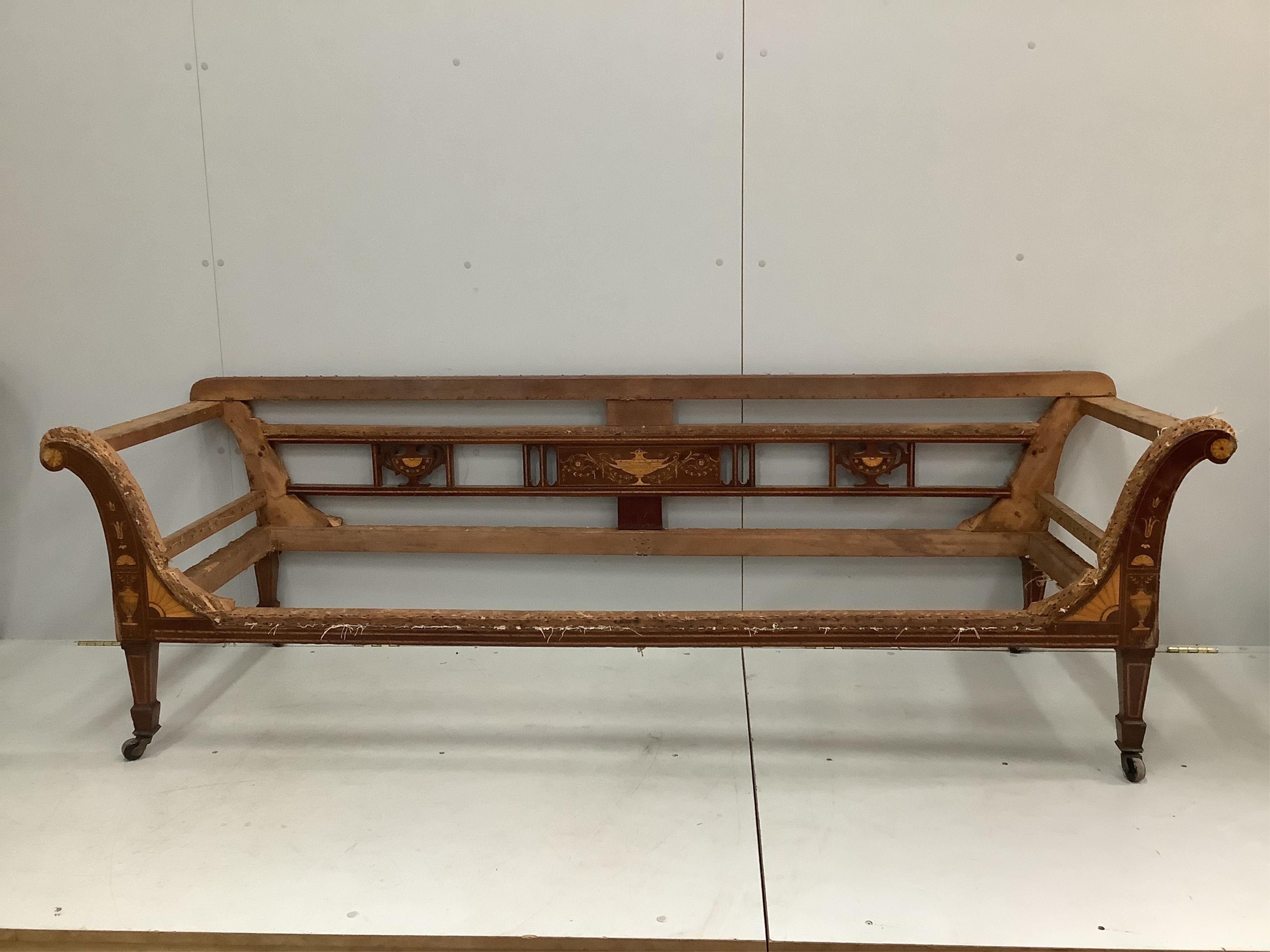 An Edwardian inlaid mahogany settee frame, width 205cm, depth 67cm, height 64cm. Condition - fair